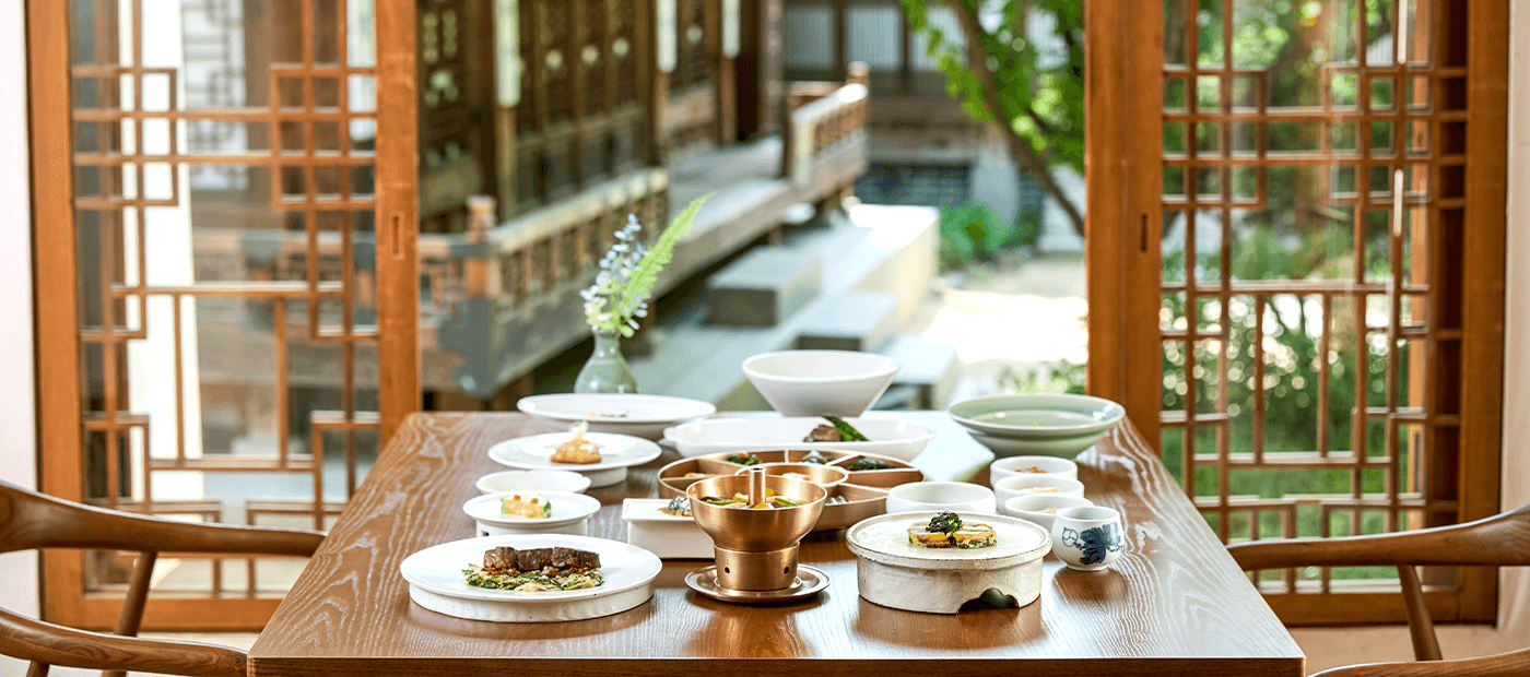 Traditional Korean tea and regional dishes arranged in a sunlit setting